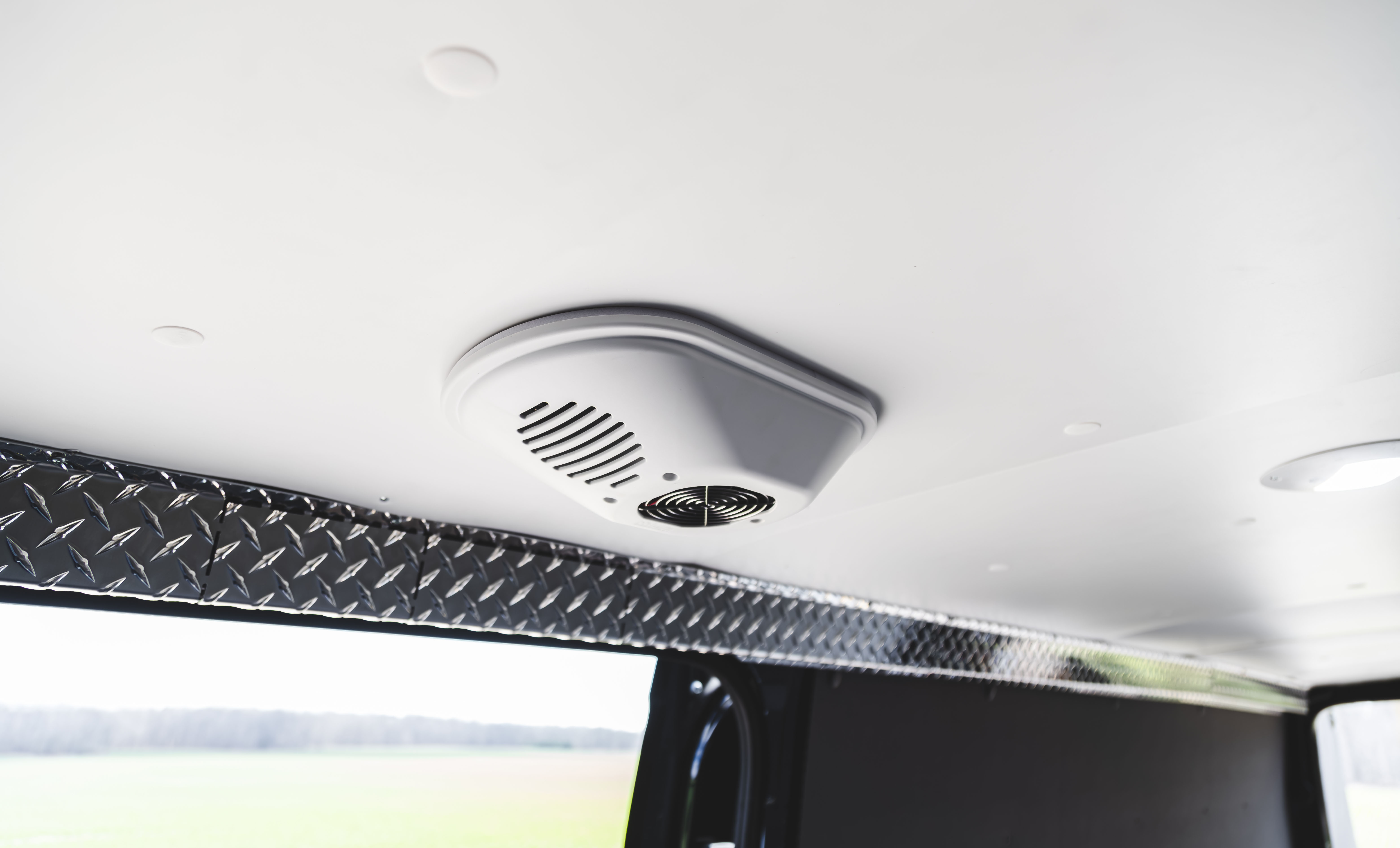 Cargo area ceiling with a lining panel fitted alongside the VanFan vent.